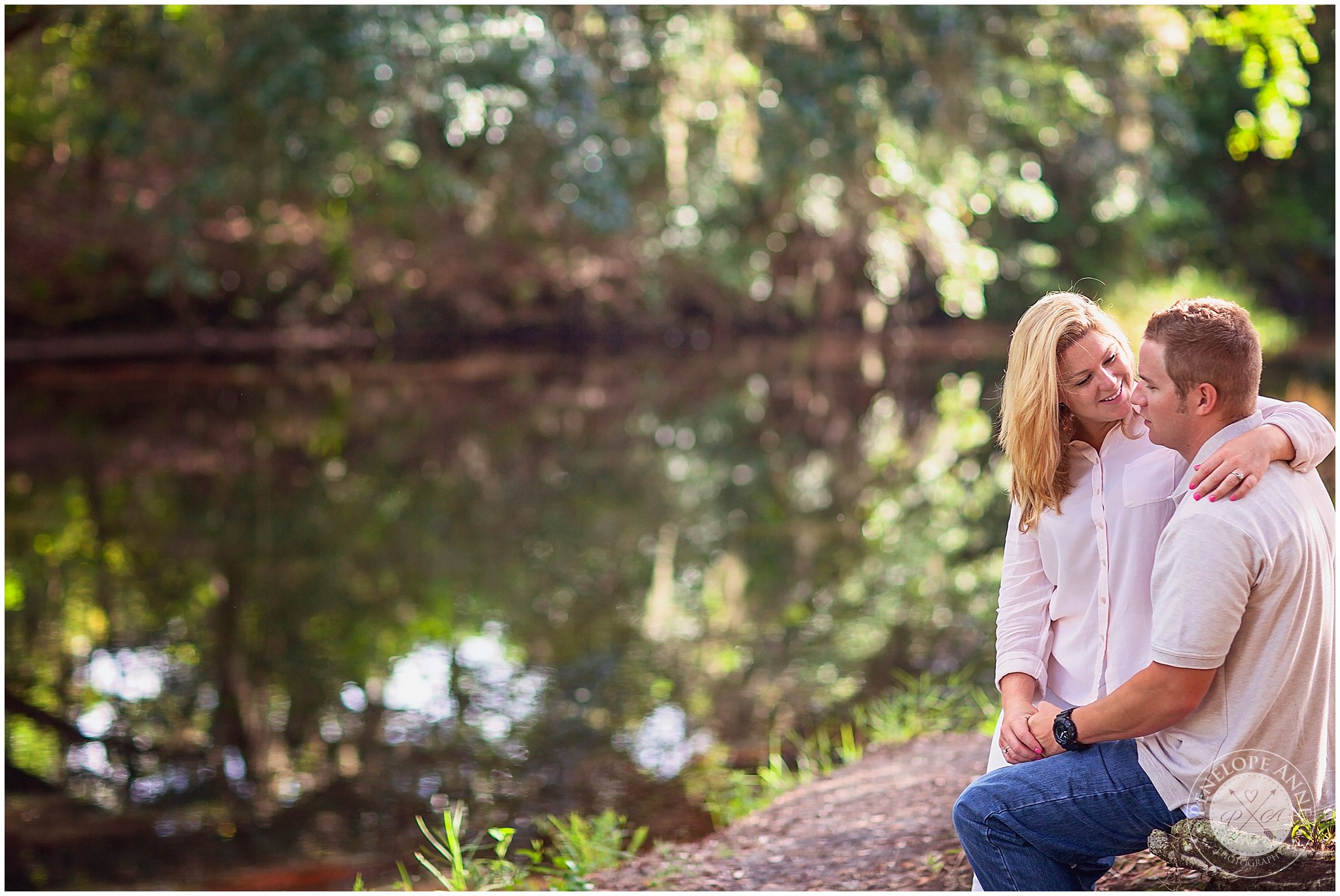 Bride and groom by water at moss park engagement session