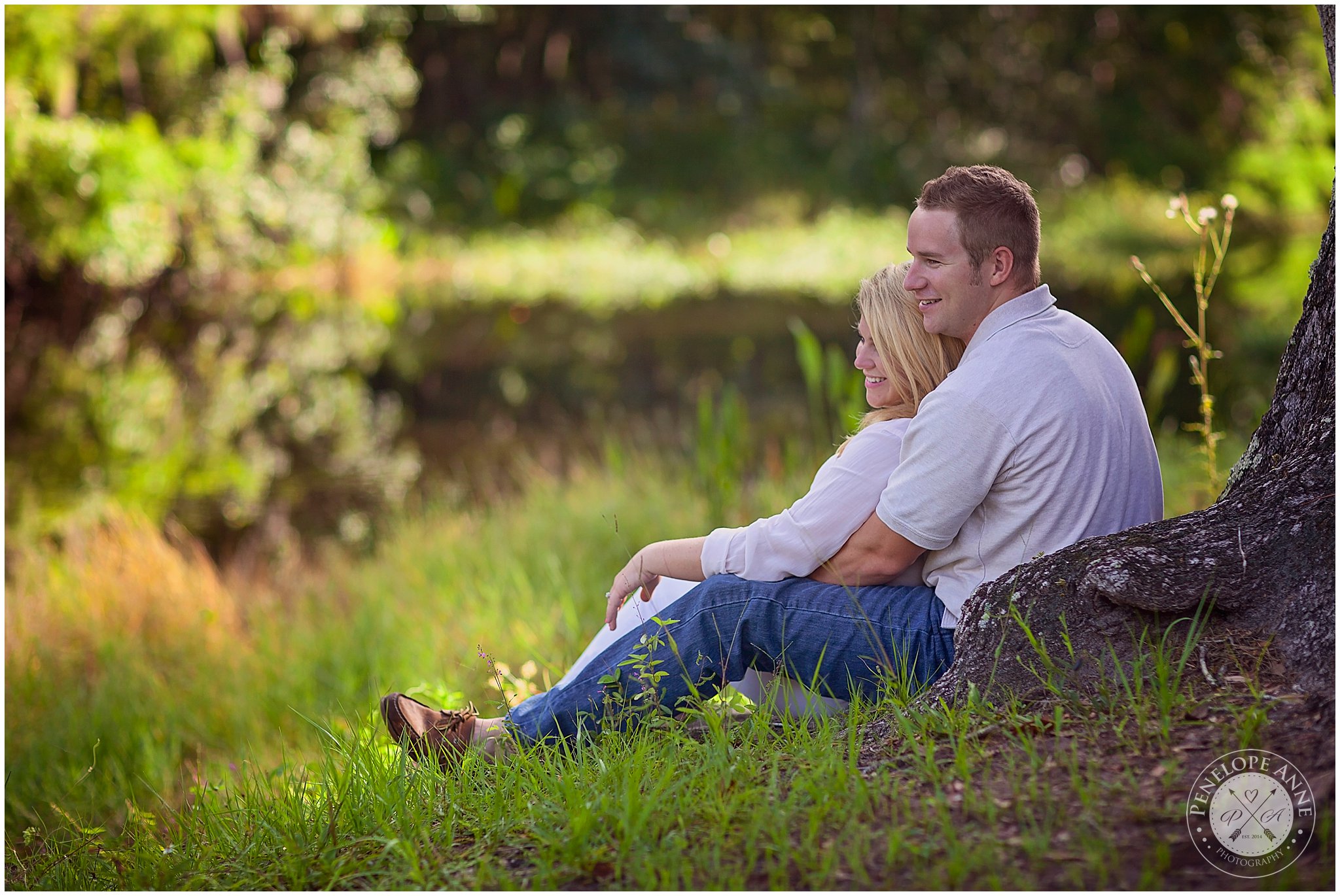 Bride and groom sitting on a tree at Moss Park Engagement Session