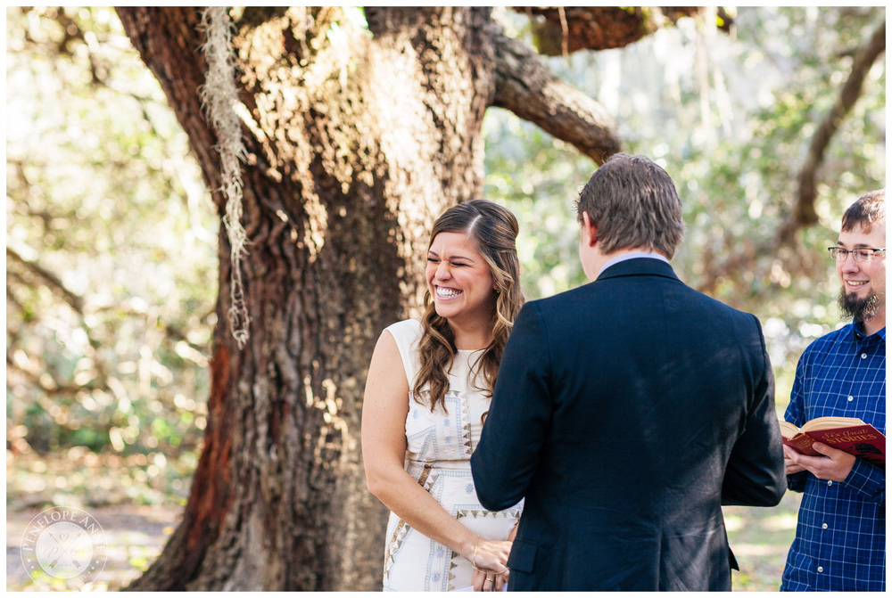 Bride laughing as groom recites his vows.