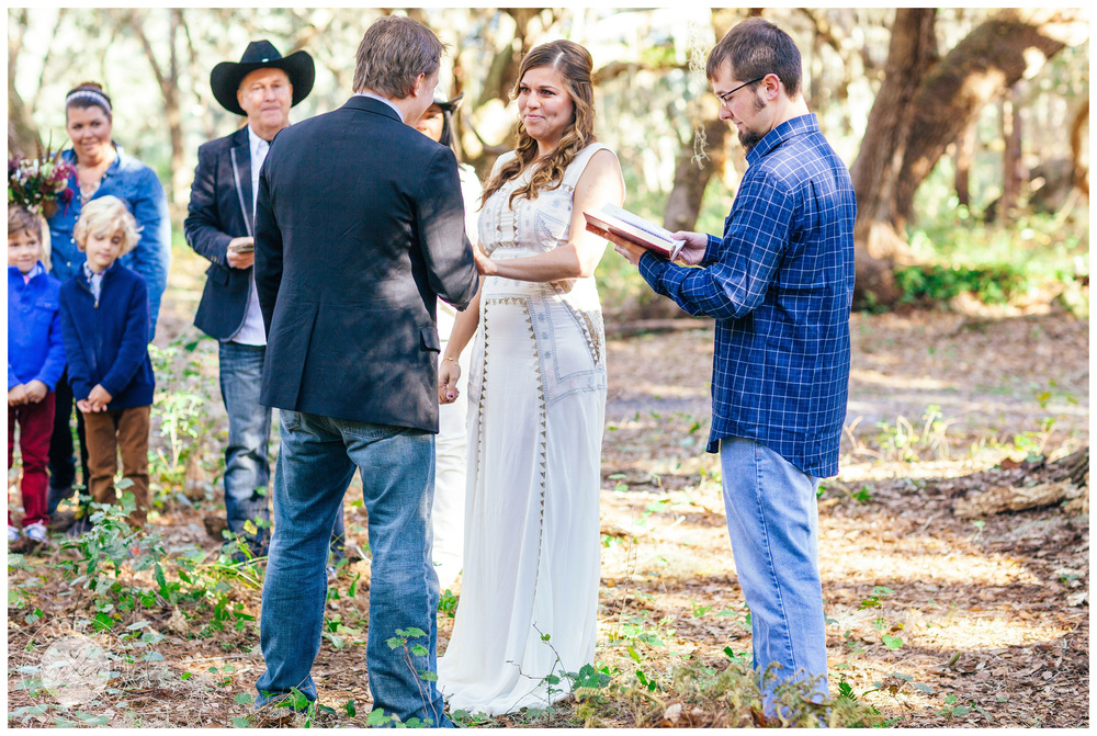 Groom putting on ring on bride