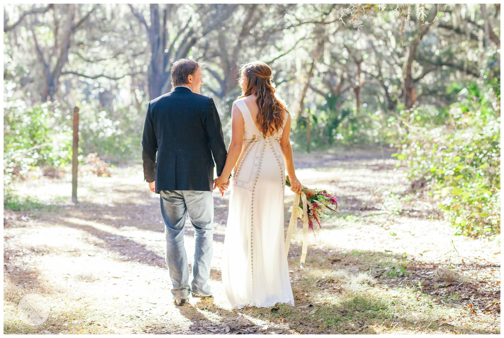 Bride and groom walking along a beautiful trail.