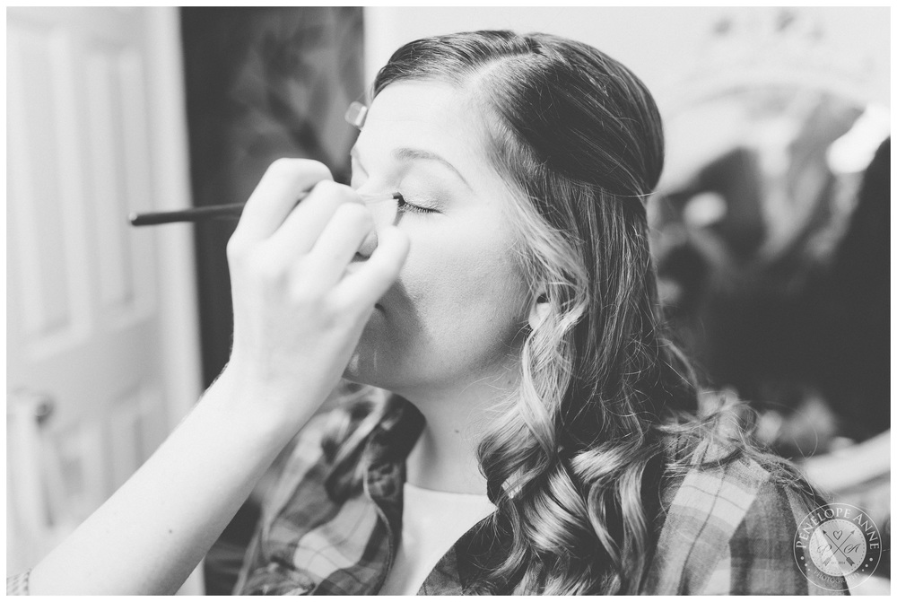 Bride getting her makeup done before the wedding