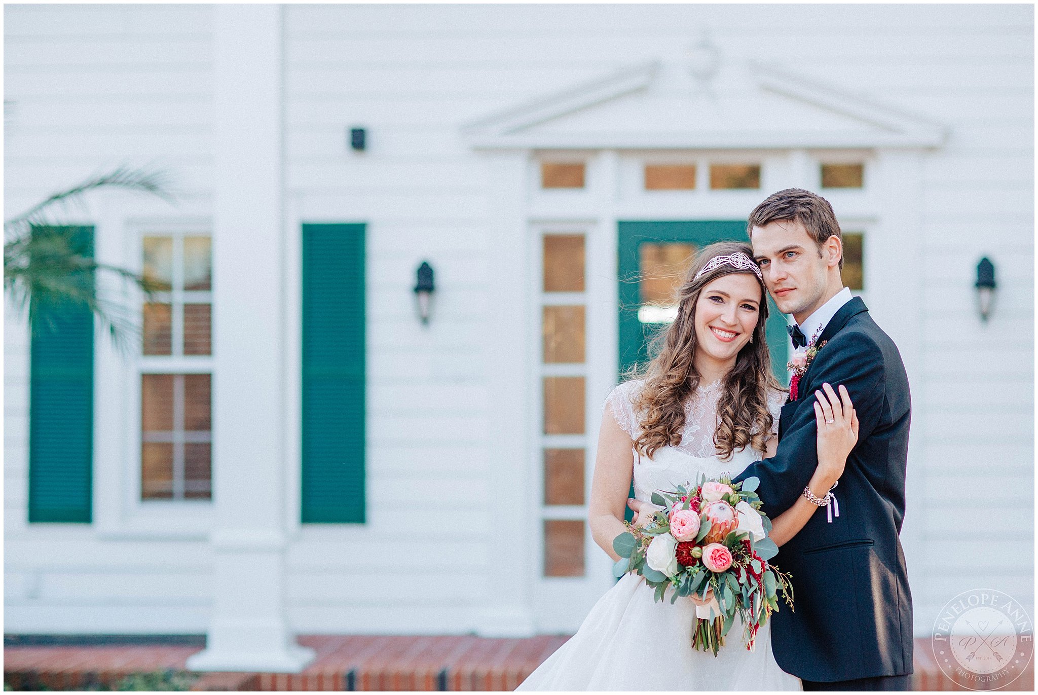 Bride and Groom standing in front of Cypress Grove Estate House