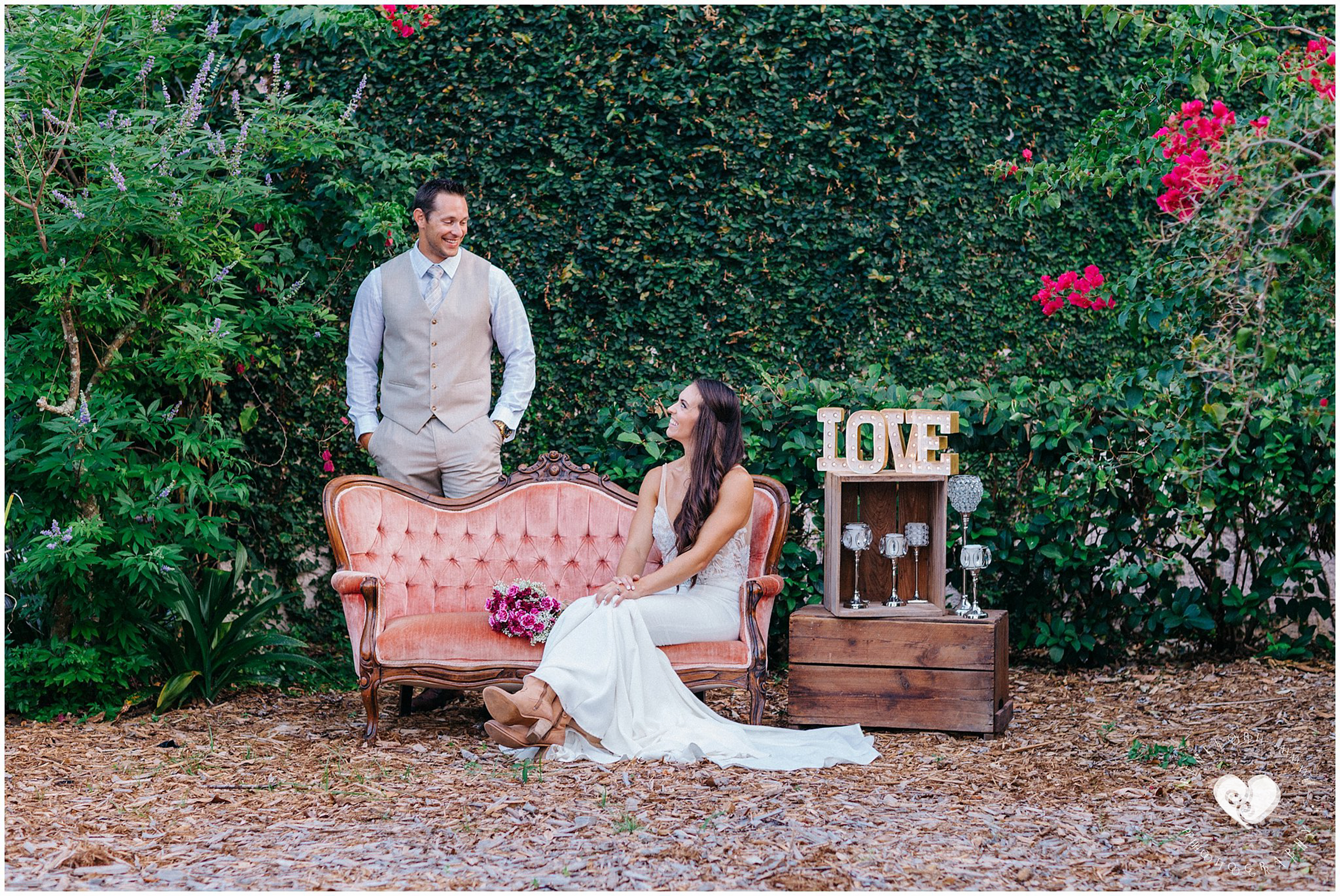 bride and groom on vintage couch