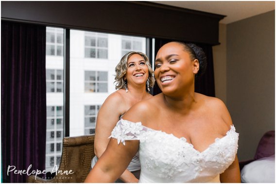 Bride laughing with maid of honor