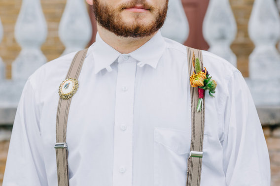 Groom wearing broach and boutonniere