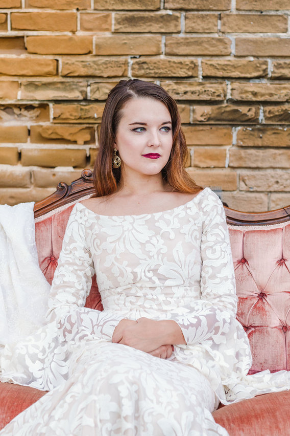 Bride sitting on vintage couch