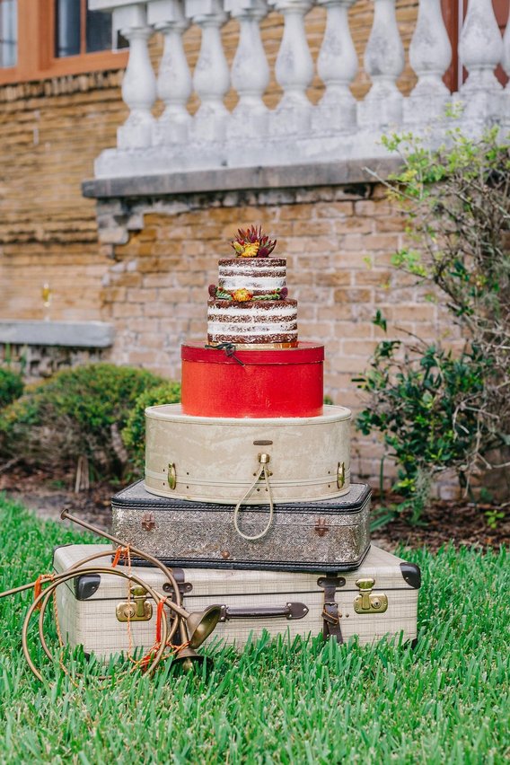 vintage wedding cake styled on luggage