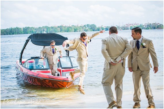 Groomsmen arrive wedding ceremony on speed boat at paradise cove