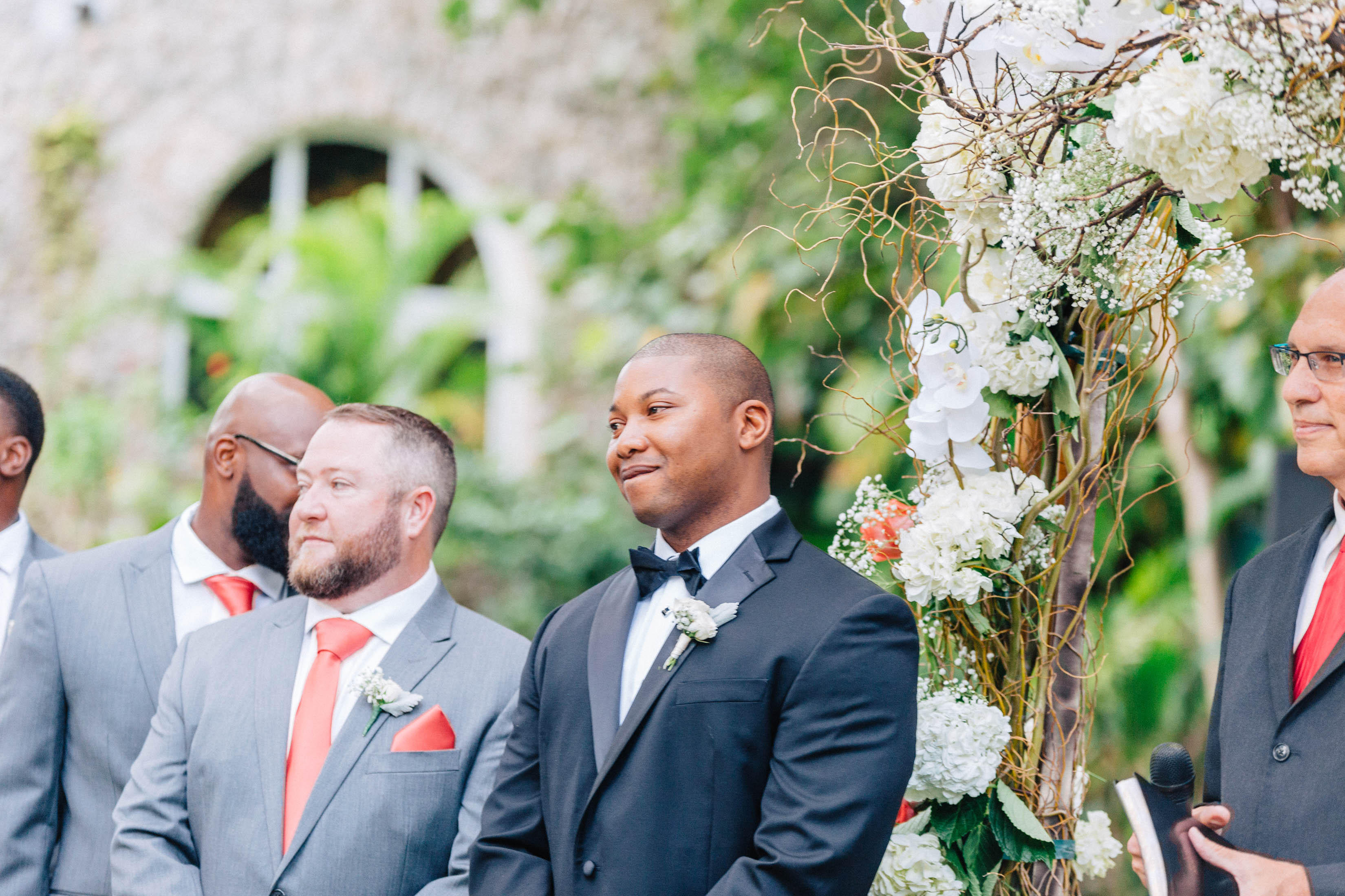 Groom watching bride walk down the altar